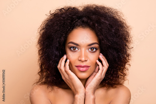 Close up photo beautiful she her dark skin model lady fluffy hairstyle hairdo overjoyed nourishing cream action salon spa procedures aesthetic pure skin wear nothing isolated pastel beige background