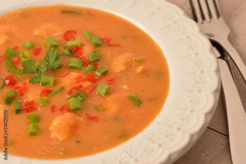 shrimp moqueca with chives, parsley and pepper