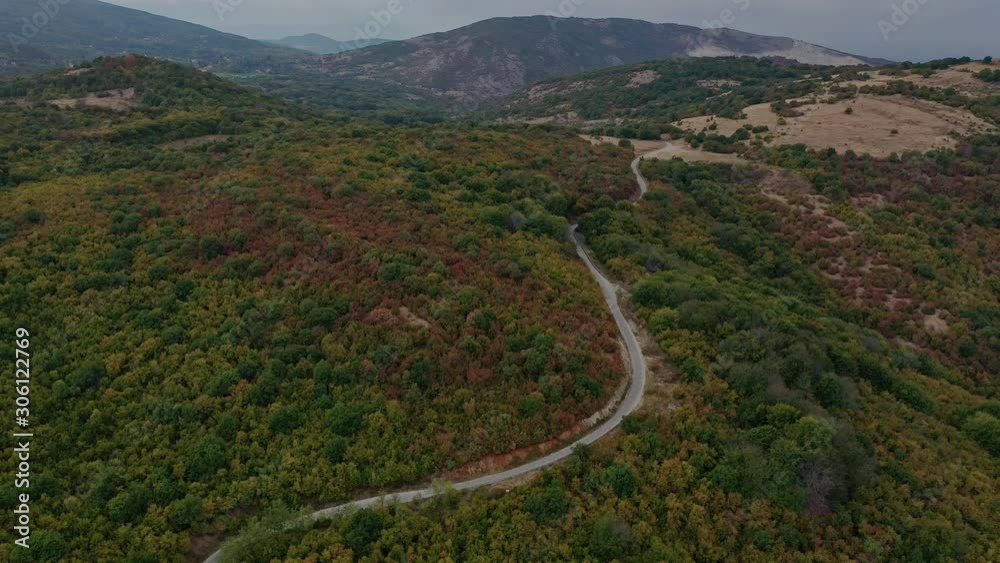 Flying over an empty road in the colorful mountains Flying over an empty road in the colorful mountains