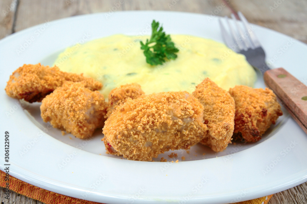 plate of chicken nuggets with mashed potatoes