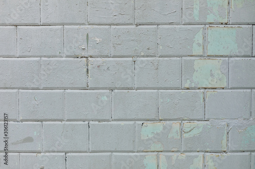 Wall of blue tiles covered with gray paint. Background. Photowall-paper. Copy space.