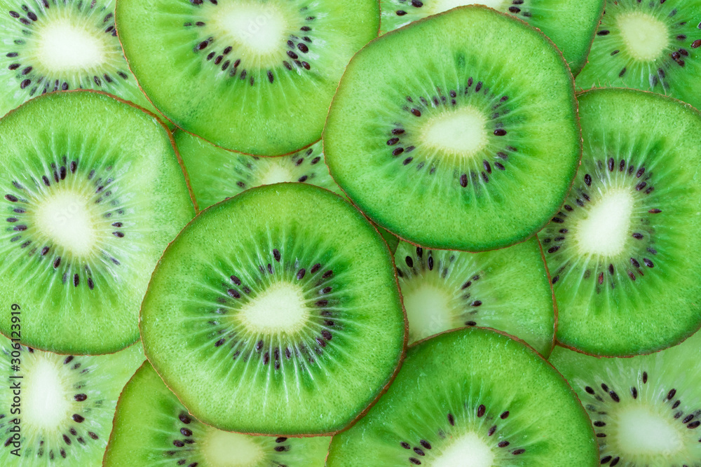Kiwi fruit slices pattern top view. Fresh juicy food background. Macro concept Kiwi fruit slices pattern top view. Fresh juicy food background. Macro concept