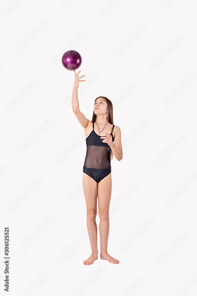 girl gymnast trains with a gymnastic ball on white background. children's professional sports. girl gymnast trains with a gymnastic ball on white background. children's professional sports.