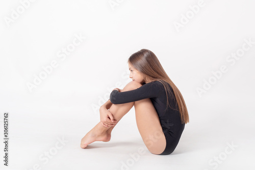 Wallpaper Mural girl gymnast trains on white background. children's professional sports. rhythmic gymnastics.  Torontodigital.ca