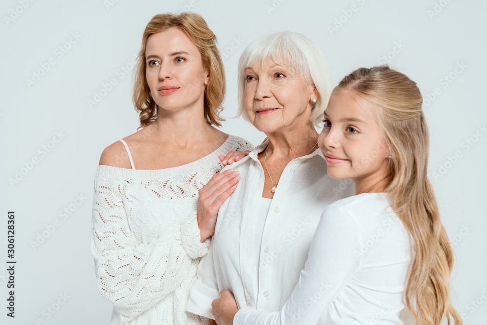 smiling granddaughter and mother hugging grandmother isolated on grey smiling granddaughter and mother hugging grandmother isolated on grey