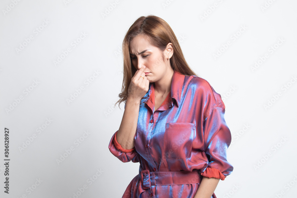 Young Asian woman holding her nose because of a bad smell. Young Asian woman holding her nose because of a bad smell.