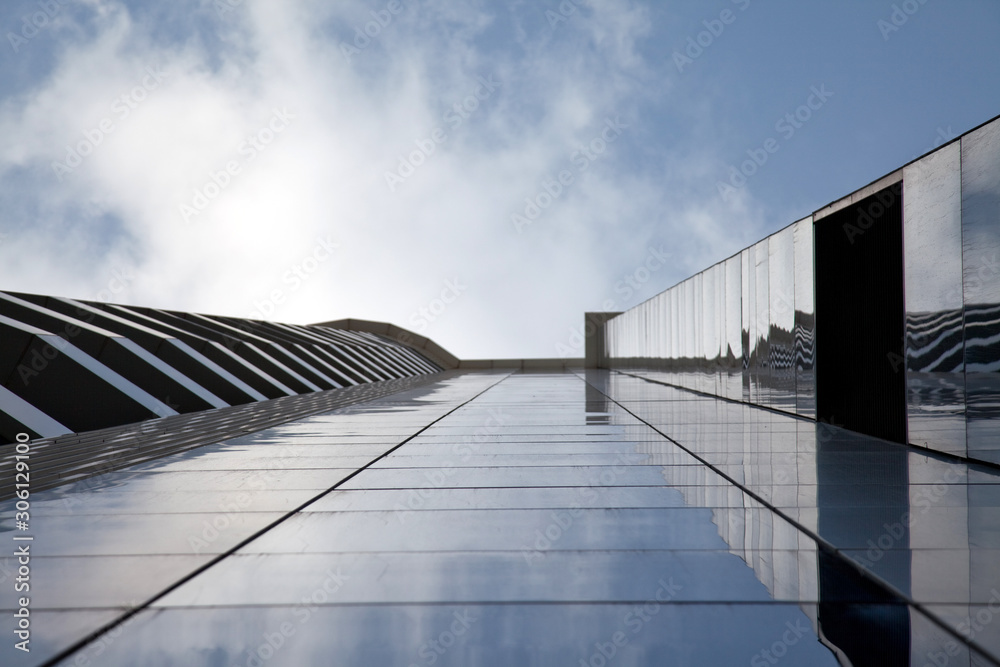 Fototapeta premium Apartment building is reflecting on the glass wall 