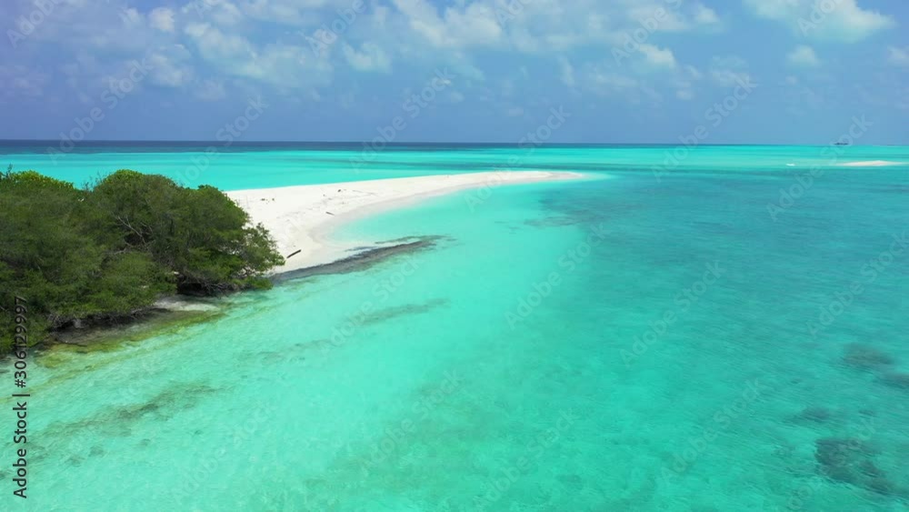 Calm clear water of azure lagoon around tropical island cape with white sandy beach on a cloudy sky in Antigua, copy space Calm clear water of azure lagoon around tropical island cape with white sandy beach on a cloudy sky in Antigua, copy space