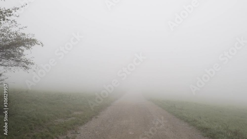 Walking on a foggy path in slow motion photo