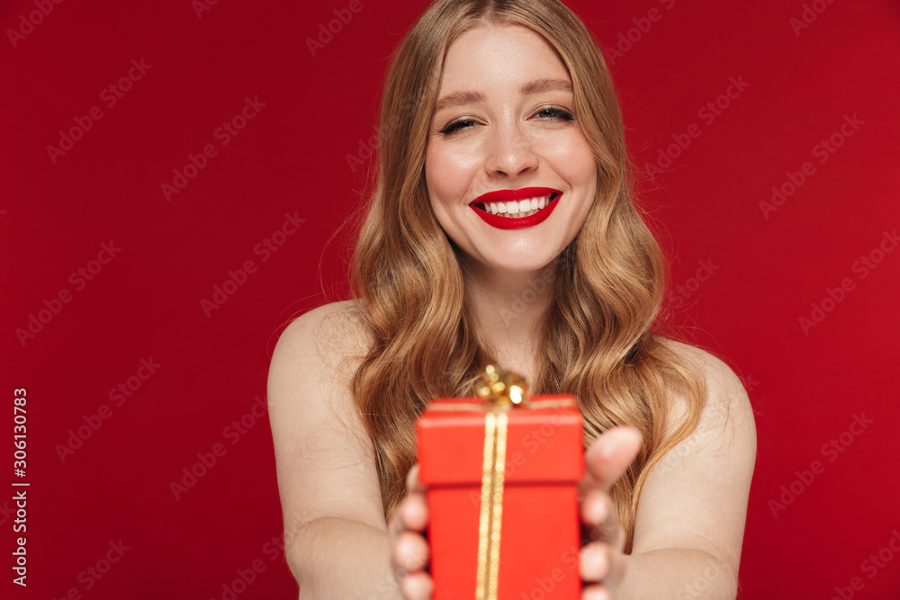 Woman posing isolated holding christmas present gift. Woman posing isolated holding christmas present gift.