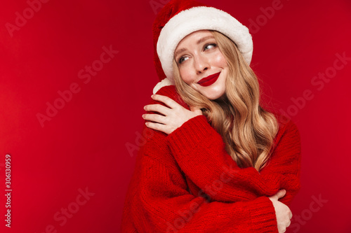 Positive caucasian woman wearing christmas hat.