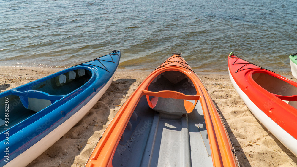 Group of colorful kayaks on water Group of colorful kayaks on water
