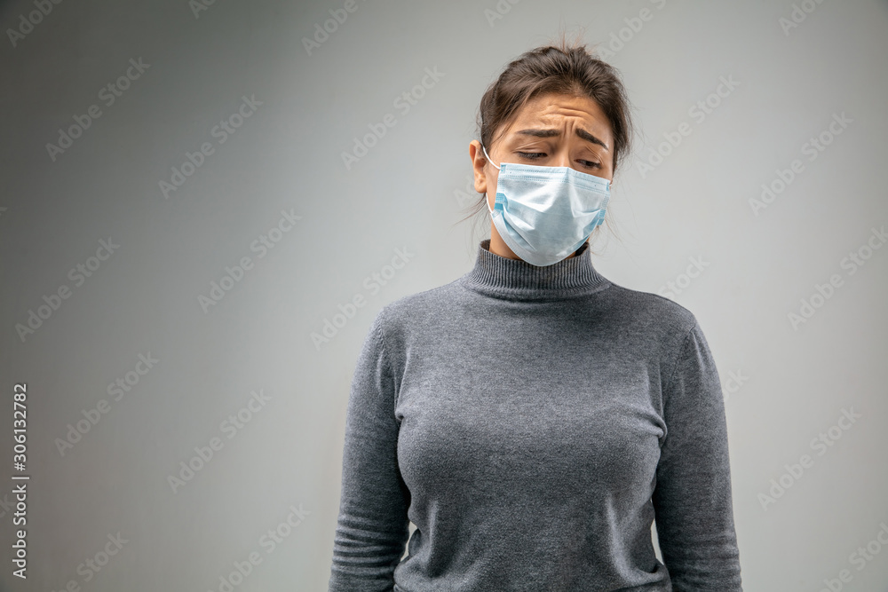 Can't breathe. Caucasian woman wearing the respiratory protection mask against air pollution and dust particles exceed the safety limits. Healthcare, environmental, ecology concept. Allergy, headache. Can't breathe. Caucasian woman wearing the respiratory protection mask against air pollution and dust particles exceed the safety limits. Healthcare, environmental, ecology concept. Allergy, headache.