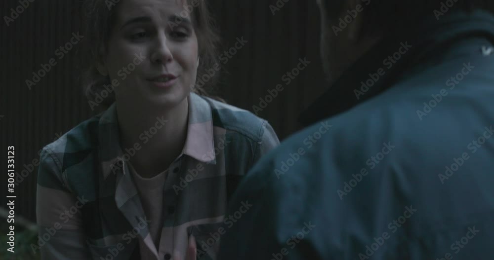 Man helps woman to after falling in forest. Shot on 4k