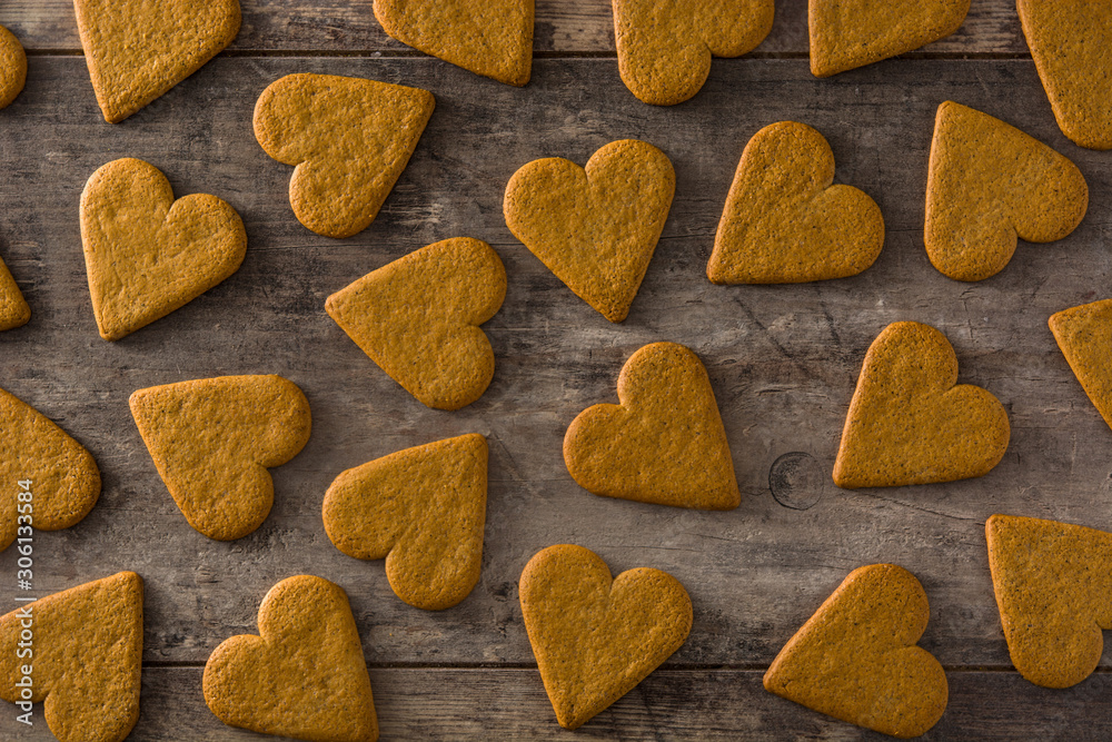 Heart shaped cookie pattern on wooden table. Valentine's Day and Mother's Day concept. Top view. Heart shaped cookie pattern on wooden table. Valentine's Day and Mother's Day concept. Top view.