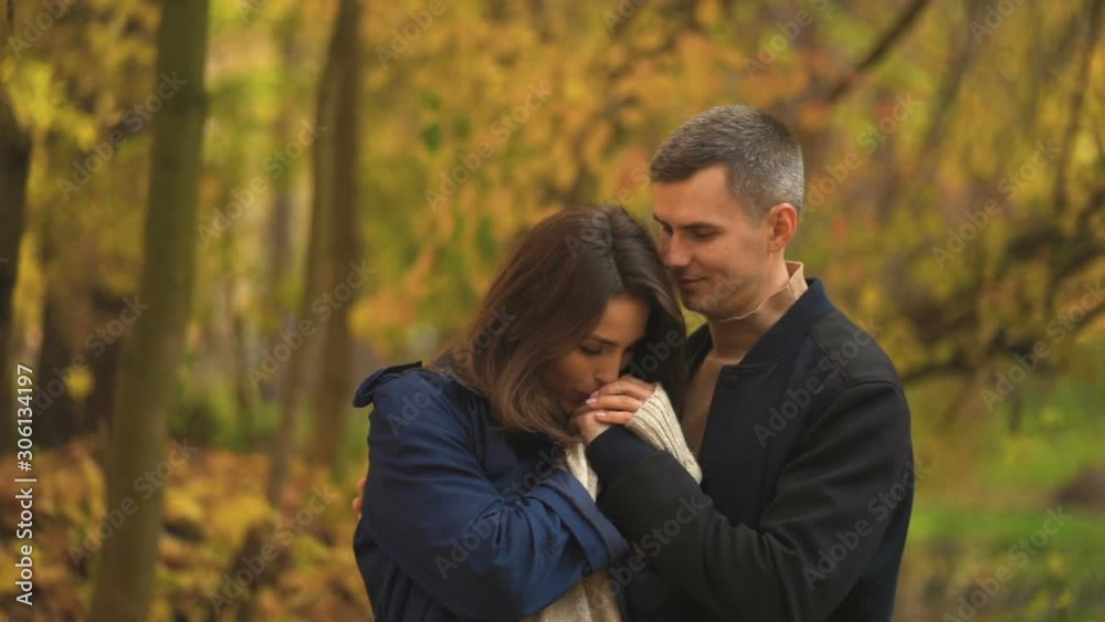 Lovers walking hand in hand in autumn park Lovers walking hand in hand in autumn park