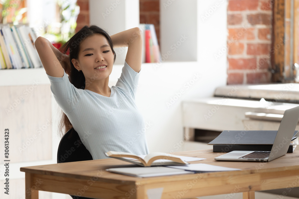 Happy young female college student relaxing during break in study. Happy young female college student relaxing during break in study.