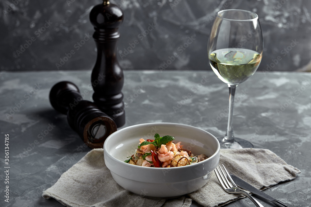 Rice noodles with shrimps and seafood, spicy asian style noodles in bowl.