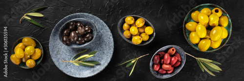 Olives variety panorama, an overhead flat lay shot on a dark background