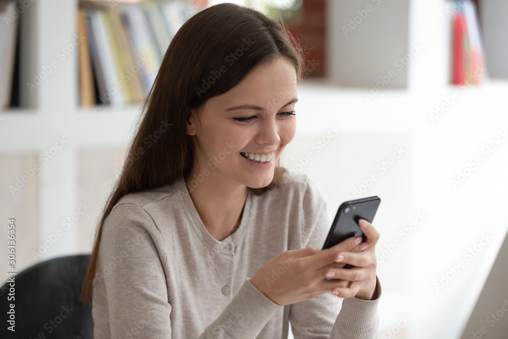 Happy young girl holding phone in hands, shopping online. Happy young girl holding phone in hands, shopping online.