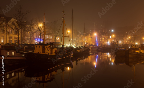 Canal  and harbor 'Noorderhaven' on a foggy night in the city of Groningen. © sanderstock