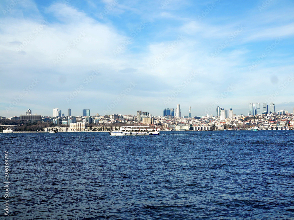 view of city through sea with ferry in Istanbul Turkey