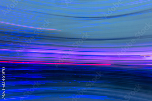 Abstract background of blue and violet light bulbs in motion