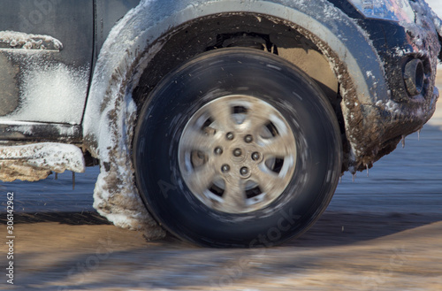 Car wheel in the snow in winter