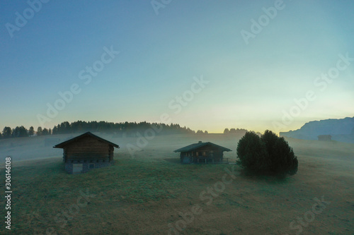 Aerial view of the valley in the fog during dawn in the Alpe di Suisi region. Dolomites in Italy in the fall photo