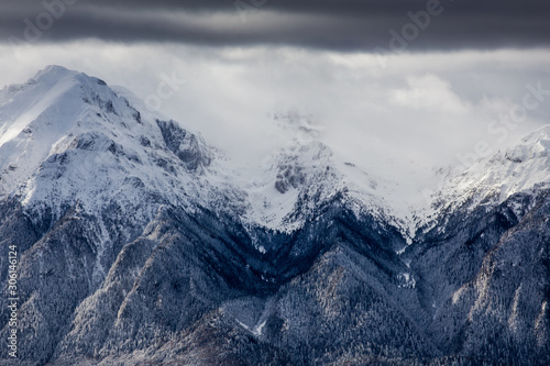 Obraz na płótnie Beautiful mountain panorama in winter with fog and clouds. Bucegi mountains seen from Postavaru, Romania. w salonie