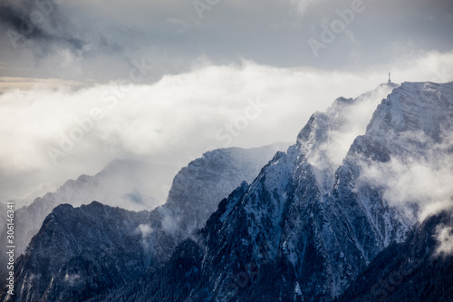 Beautiful mountain panorama in winter with fog and clouds. Bucegi mountains seen from Postavaru  Romania.