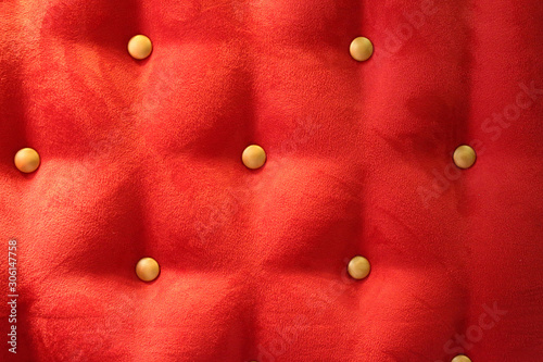 red upholstery background with gold buttons
