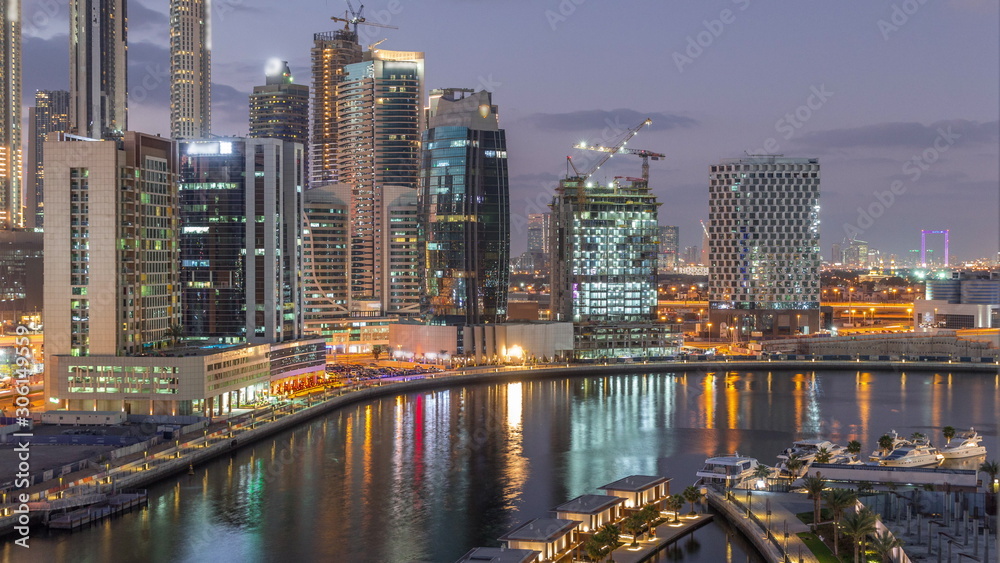 Dubai skyscrapers after sunset near river aerial day to night timelapse