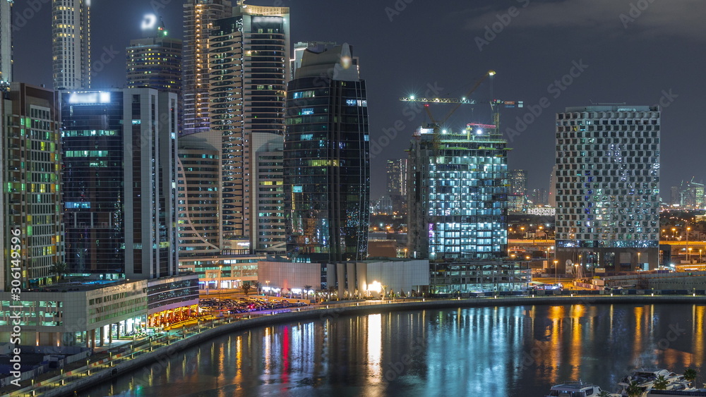 Night city Dubai near canal aerial timelapse
