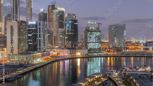 Dubai skyscrapers after sunset near river aerial day to night timelapse