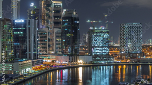 Night city Dubai near canal aerial timelapse