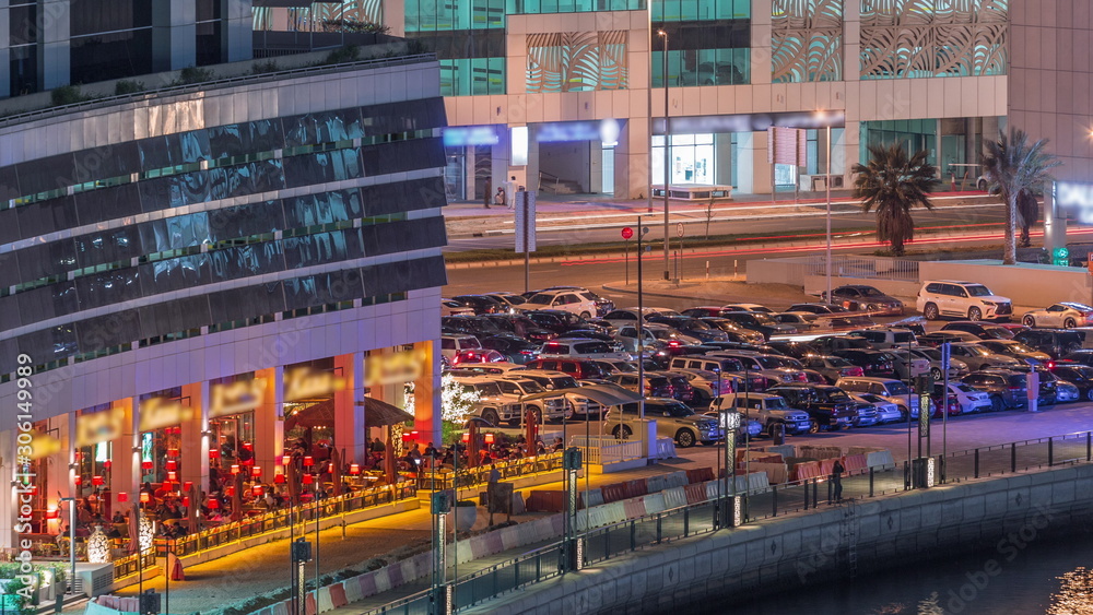 Parking near canal in Dubai at night, UAE aerial timelapse Parking near canal in Dubai at night, UAE aerial timelapse