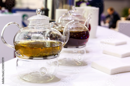 Transparent glass teapot with tea leaves