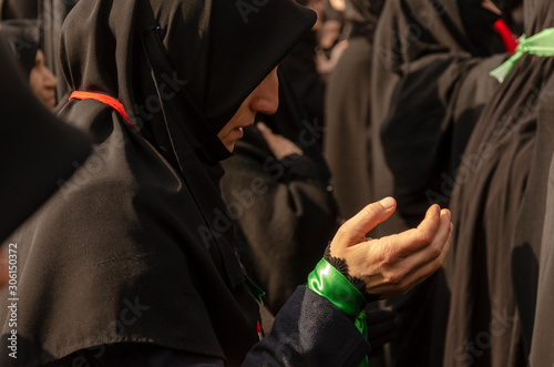 Ashura (asura or asure) ceremony in istanbul. Turkish Shiite woman mourn and pray for Husayn who killed in Battle of Karbala.  photo