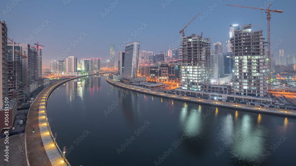 Fototapeta premium The rhythm of the city of Dubai from night to day transition aerial timelapse