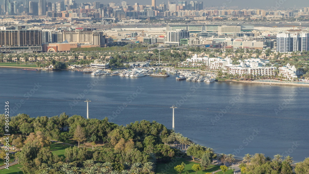 Aerial view of blue canal near green park Dubai city, United Arab Emirates Timelapse