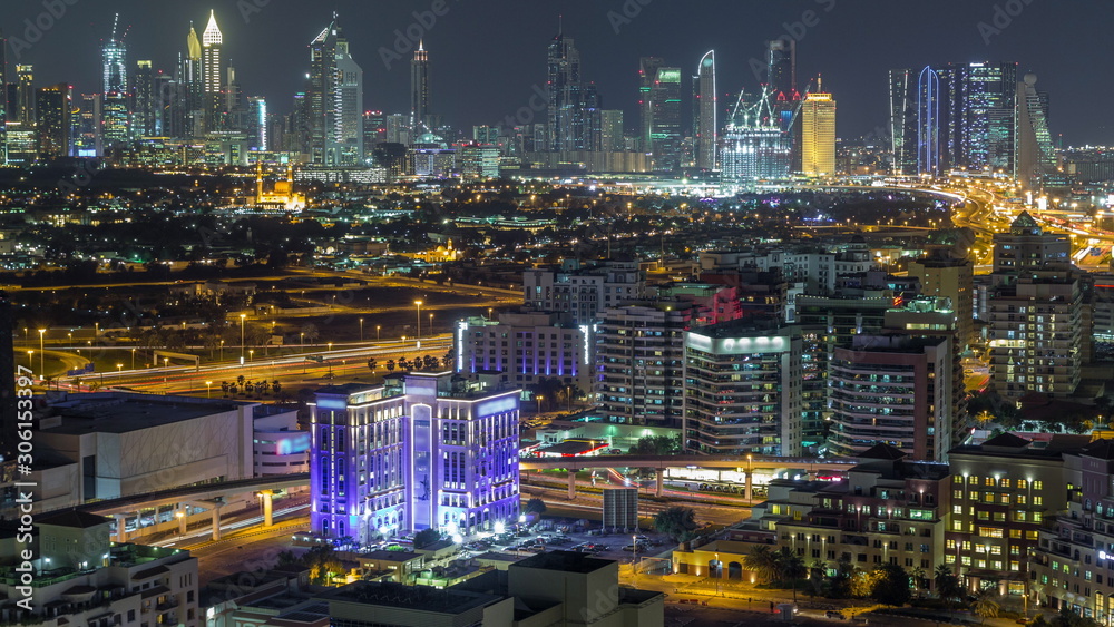 Modern view of illuminated buildings appartments and skyscrapers in Dubai Timelapse Aerial