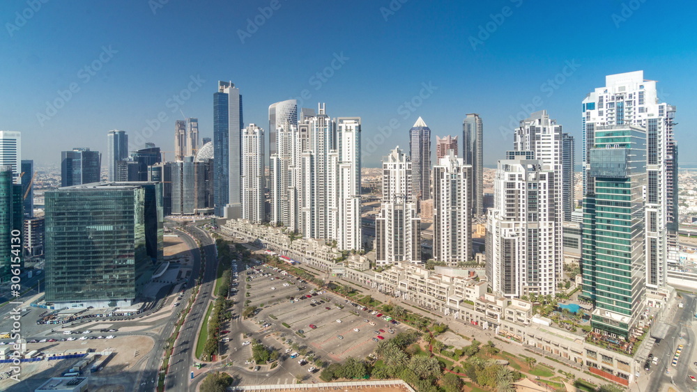 Fototapeta premium Modern residential and office complex with many towers aerial timelapse at Business Bay, Dubai, UAE.