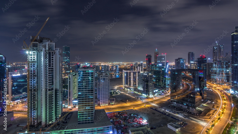 Naklejka premium Aerial view of illuminated buildings and high traffic in modern Dubai city, United Arab Emirates Timelapse Aerial