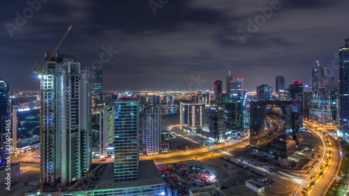 Wallpaper Mural Aerial view of illuminated buildings and high traffic in modern Dubai city, United Arab Emirates Timelapse Aerial Torontodigital.ca