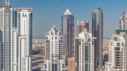 Modern residential and office complex with many towers aerial timelapse at Business Bay  Dubai  UAE.