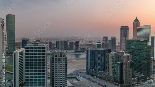 Dubai s business bay towers at evening aerial timelapse.