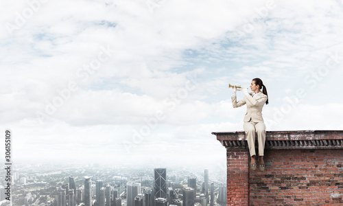 Attractive young woman playing trumpet on roof © adam121