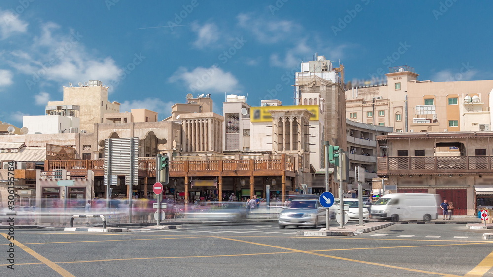 Traffic on intersection near entrance to the Gold Souk timelapse in Deira in Dubai