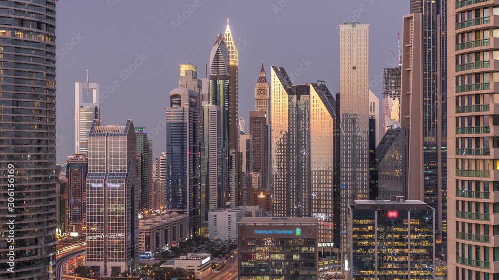 Dubai International Financial Centre district with modern skyscrapers day to night timelapse